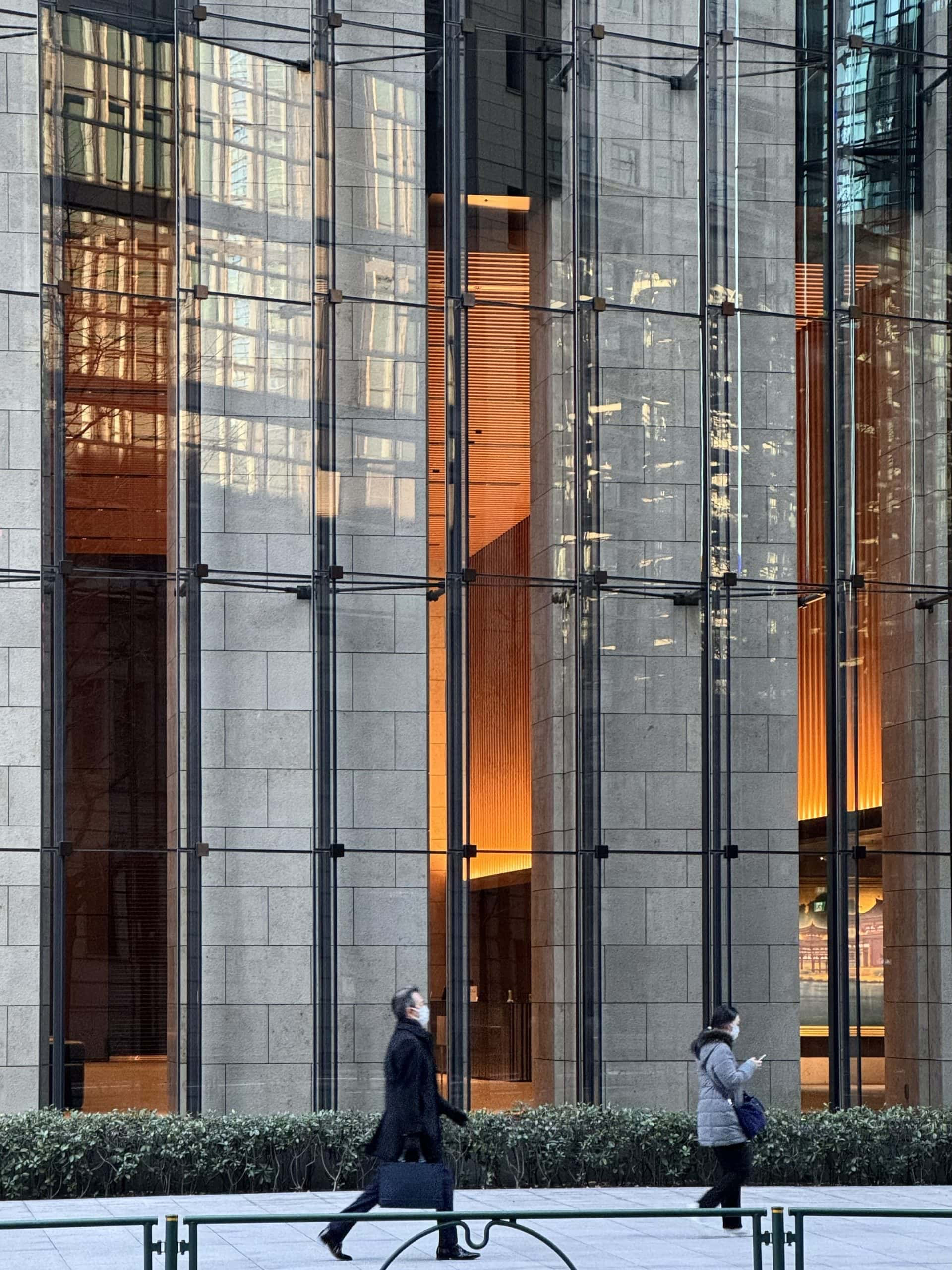A play of architectural shadows and reflections on the glass panels of an office building in the Otemachi district of Tokyo. © 2025 Norbert Woehnl Photography.